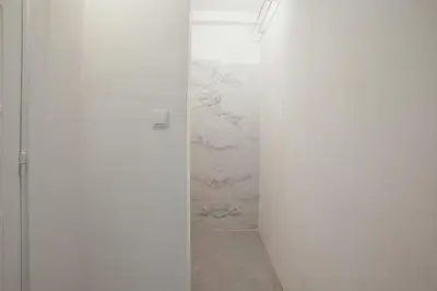 a room with a white wall with a marble wall at Clerigos Loft by Hosty in Porto