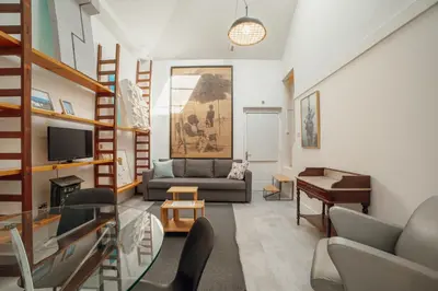 a living room with a couch and a piano at Clerigos Loft by Hosty in Porto