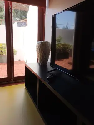 a flat screen tv sitting on top of a dresser at Porto Studio in Porto