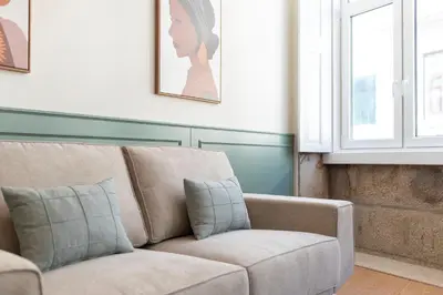 a living room with a couch and a window at Doispontozero Alegria Green in Porto