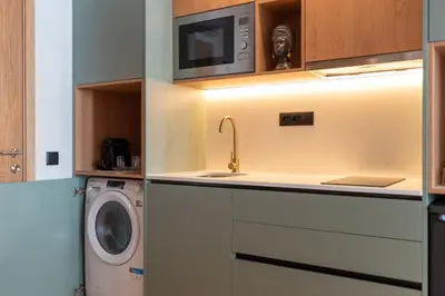 a kitchen with a sink and a washing machine at Doispontozero Alegria Green in Porto