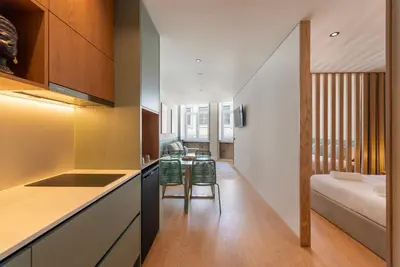a kitchen with a counter top and a living room at Doispontozero Alegria Green in Porto
