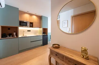 a kitchen with a large mirror on the wall at Doispontozero Alegria Green in Porto