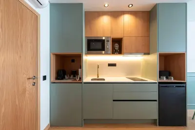 a kitchen with wooden cabinets and a microwave at Doispontozero Alegria Green in Porto