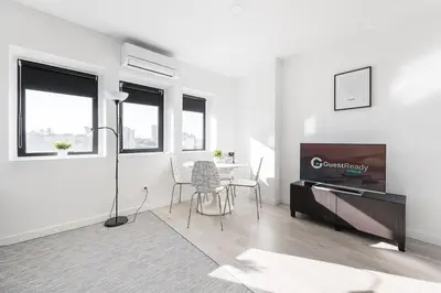 a white living room with a table and a television at GuestReady - Porto Saudade in Porto