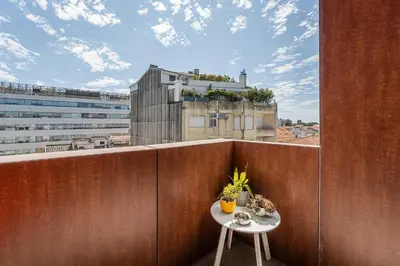 a table on a balcony with a view of a building at GuestReady - Teddy Jazz in Porto