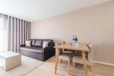 a living room with a table and a couch at GuestReady - Mushroom in Porto