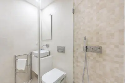 a bathroom with a toilet and a sink and a shower at GuestReady - Mushroom in Porto