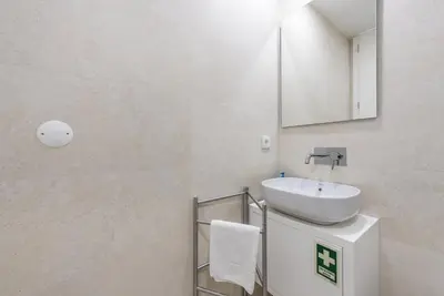 a white bathroom with a sink and a mirror at GuestReady - Mushroom in Porto