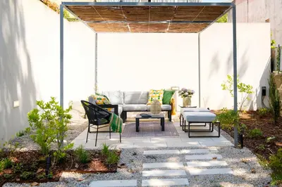 a white bedroom with a bed and a window at Boavista Central Garden & Terrace in Porto