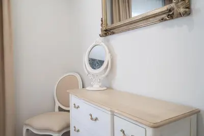 a dressing table with a mirror and a chair at GuestReady - Stylish stay with balcony in Gaia in Vila Nova de Gaia
