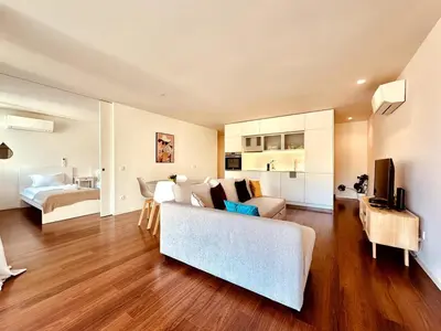 a living room with a couch and a bedroom at Bombarda 250 E in Porto
