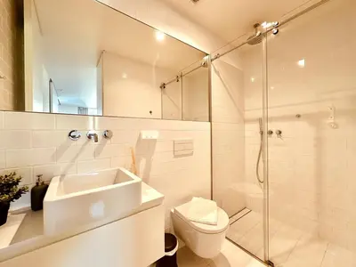 a bathroom with a shower and a sink and a toilet at Bombarda 250 E in Porto