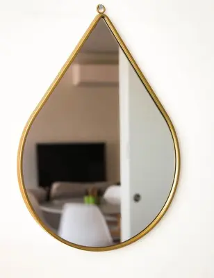 a mirror hanging on a wall with a living room at Bombarda 250 E in Porto