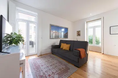 a living room with a couch and a tv at Apartment Alegria Street by Sweet Porto - Free Parking in Porto