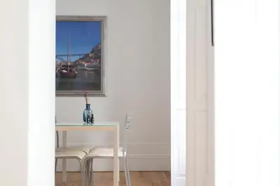 a dining room with a table and chairs and a window at Apartment Alegria Street by Sweet Porto - Free Parking in Porto