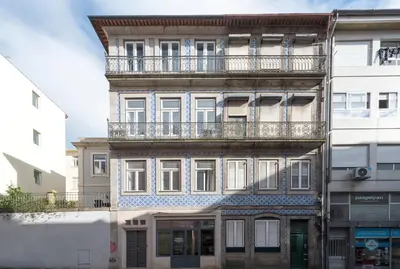 a tall building with a balcony on top of it at Apartment Alegria Street by Sweet Porto - Free Parking in Porto