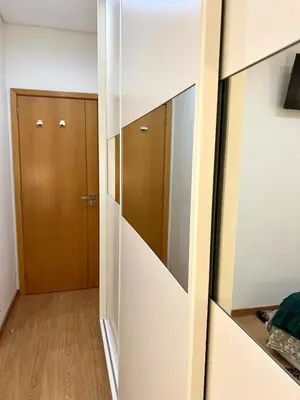 a walk in wardrobe in a room with wooden doors at Douro Residence Porto Gaia in Vila Nova de Gaia