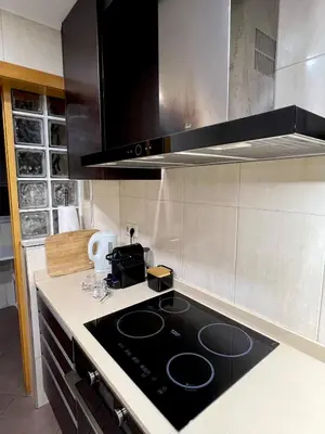 a kitchen with a black stove top in a kitchen at Douro Residence Porto Gaia in Vila Nova de Gaia
