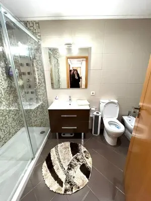 a bathroom with a sink and a toilet and a mirror at Douro Residence Porto Gaia in Vila Nova de Gaia