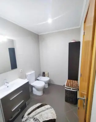 a bathroom with a toilet and a sink at Douro Residence Porto Gaia in Vila Nova de Gaia
