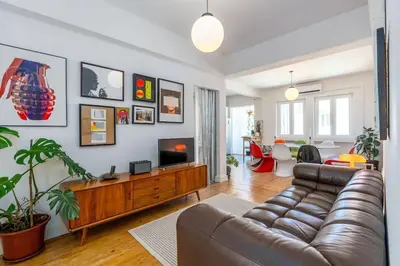 a living room with a couch and a flat screen tv at St Catarina 555 Apartment in Porto