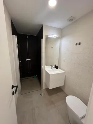 a bathroom with a sink and a shower and a toilet at Cozy Retreat - Modern T1 in Porto