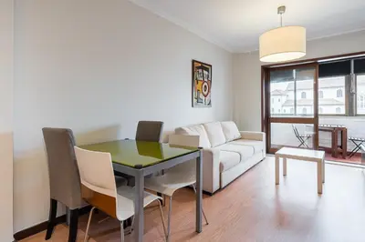 a living room with a table and a couch at GuestReady - Central Porto Gem in Porto