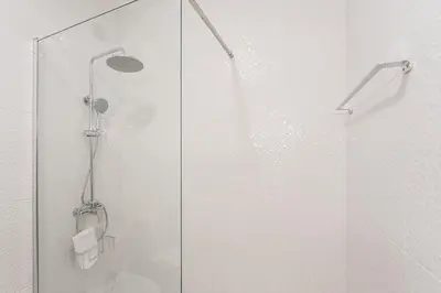 a bathroom with a shower with a glass door at GuestReady - Central Porto Gem in Porto