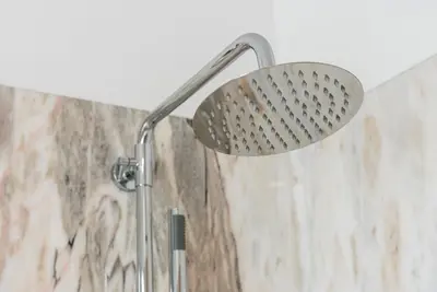 a shower with a shower head in a bathroom at GuestReady - Blueberry Pie in the Balcony in Porto