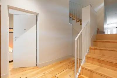 a sliding glass door in a hallway with wood floors at Host Wise - Stylish Urban Flat with Terrace in Porto