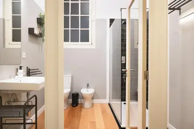 a bathroom with a toilet and a sink at 42 2 F Historical apartment at Cardosas Block in Porto