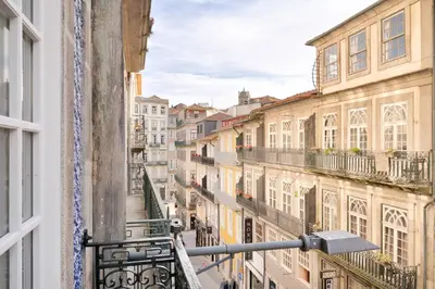 a view of a city street from a balcony at 42 2 F Historical apartment at Cardosas Block in Porto