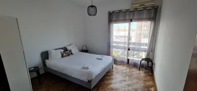 a small bedroom with a bed and a window at Leote in Porto