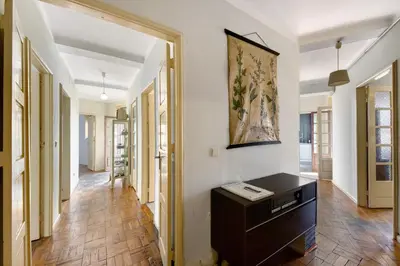 a hallway with a desk and a painting on the wall at A Casa Formosa in Porto