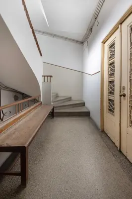 an empty room with a wooden bench and a door at A Casa Formosa in Porto
