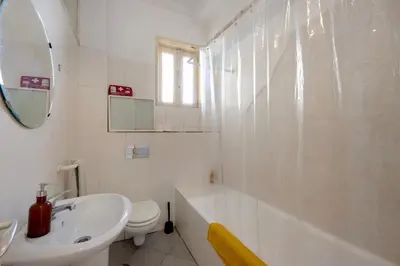 a white bathroom with a sink and a toilet at A Casa Formosa in Porto