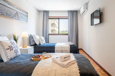 a bedroom with a bed and a couch at Host Wise - Bright and Elegant Urban Flat with Balcony in Porto