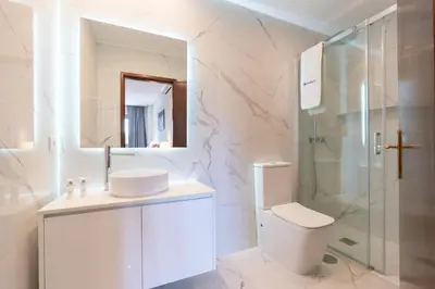 a bathroom with a toilet and a sink and a shower at Host Wise - Bright and Elegant Urban Flat with Balcony in Porto