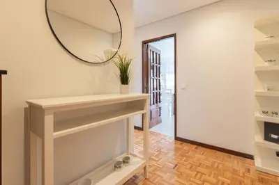 a dressing room with a mirror and a table at Host Wise - Bright and Elegant Urban Flat with Balcony in Porto