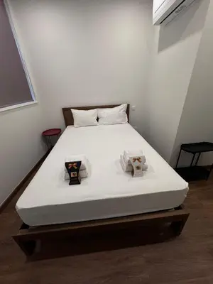 a white bed in a room with two boxes on it at River Apartment in Porto