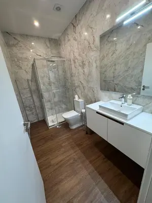 a bathroom with a sink and a shower and a toilet at River Apartment in Porto