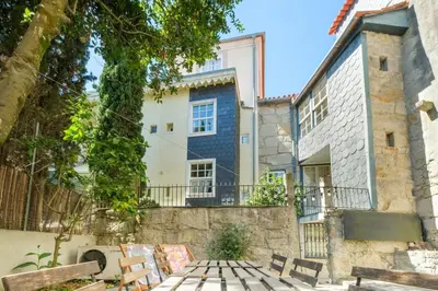 a living room with a couch and a window at GuestReady - Historic Courtyard Townhouse in Porto