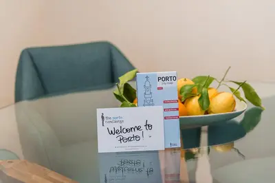 two signs on a table with a bowl of fruit at GuestReady - Contemporary cabin in Santos Pousada in Porto