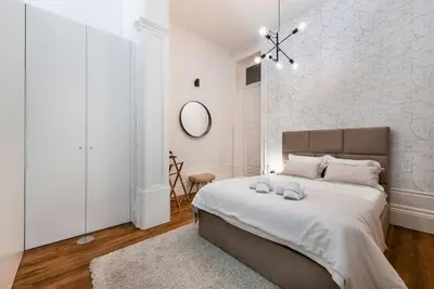 a bedroom with a large bed and a mirror at GuestReady - Naoki Studio in Porto