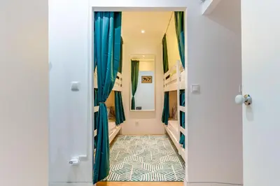 a hallway with blue drapes and a tile floor at Cozy Nest in Porto