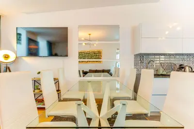a kitchen and dining room with a glass table and chairs at Cozy Nest in Porto