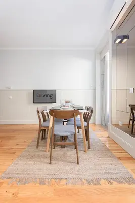 a dining room with a wooden table and chairs at Liiiving in Porto - Bolhao Garden Apartment in Porto
