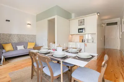 a dining room and living room with a table and chairs at Liiiving in Porto - Bolhao Garden Apartment in Porto