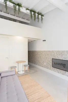 a room with a table and two stools at Liiiving in Porto - Bolhao Garden Apartment in Porto